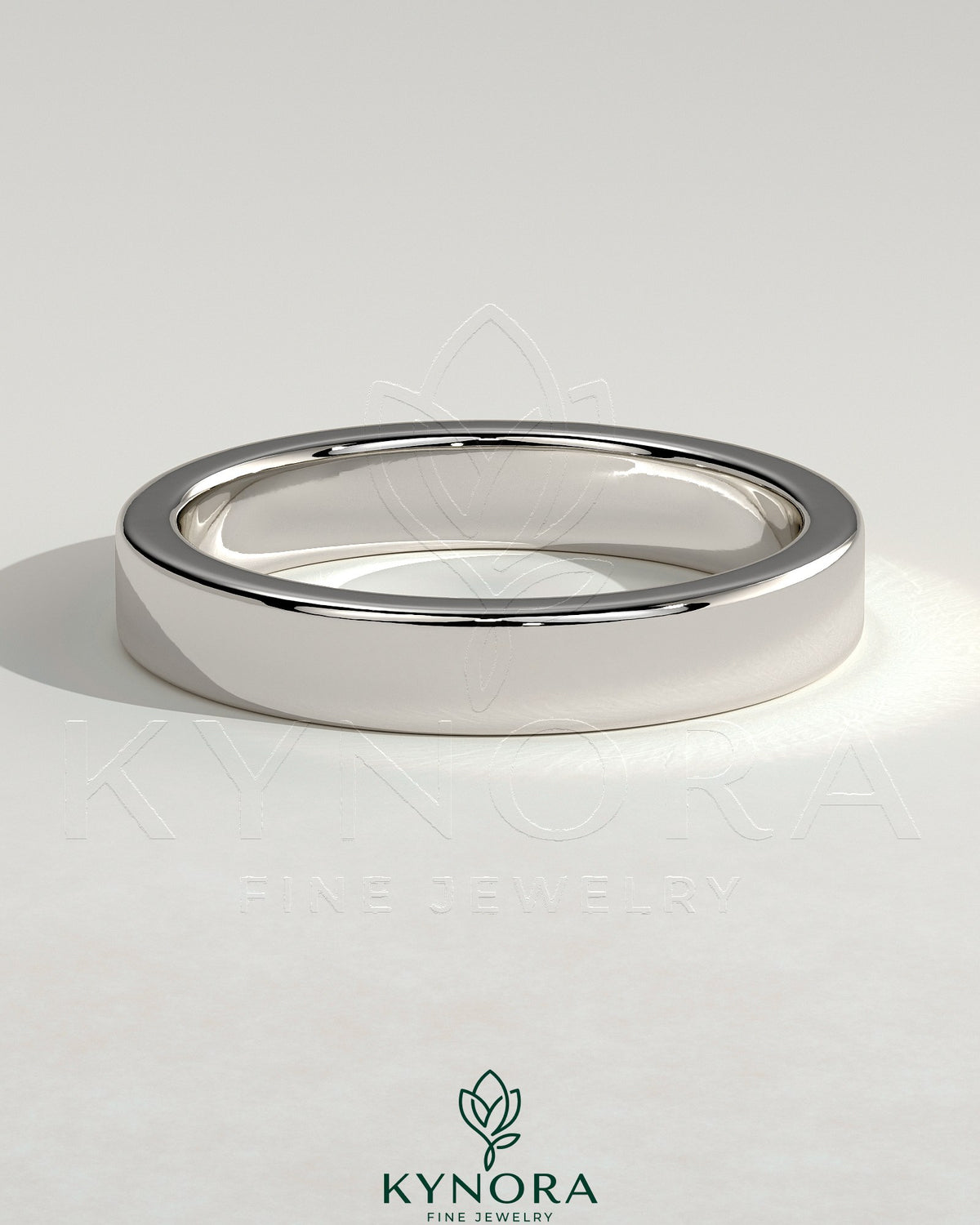 Kynora CJ flat cigar band wedding ring with a smooth, matte finish in gold, showcasing a simple, elegant design.