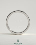 Kynora CJ flat cigar band wedding ring with a smooth, polished gold finish, showcasing a simple and elegant design.