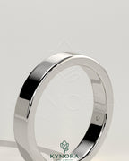 Kynora CJ flat cigar band wedding ring with a smooth, wide gold finish, showcasing a sleek and elegant design.