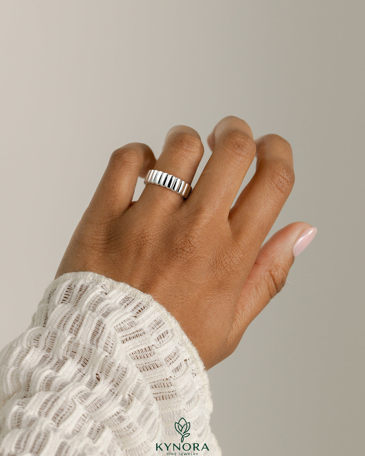Kynora CJ fluted cigar wedding ring band with a textured design, crafted for elegant wedding jewelry.