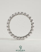 Kynora CJ full round eternity wedding band with scalloped setting, crafted in polished metal, featuring continuous sparkling gemstones.