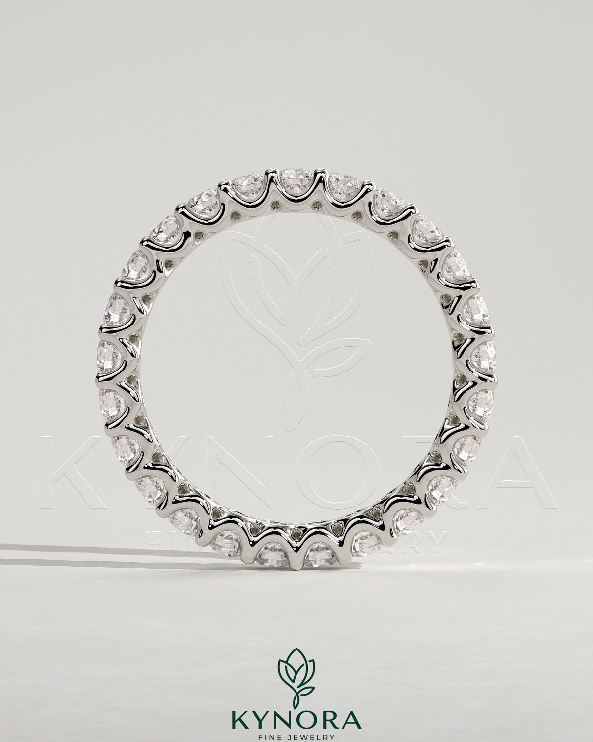 Kynora CJ full round eternity wedding band with scalloped setting, crafted in polished metal, featuring continuous sparkling gemstones.