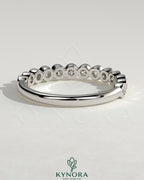Kynora CJ Half Eternity round bezel set wedding band with sparkling diamonds, elegant gold wedding ring for special occasions