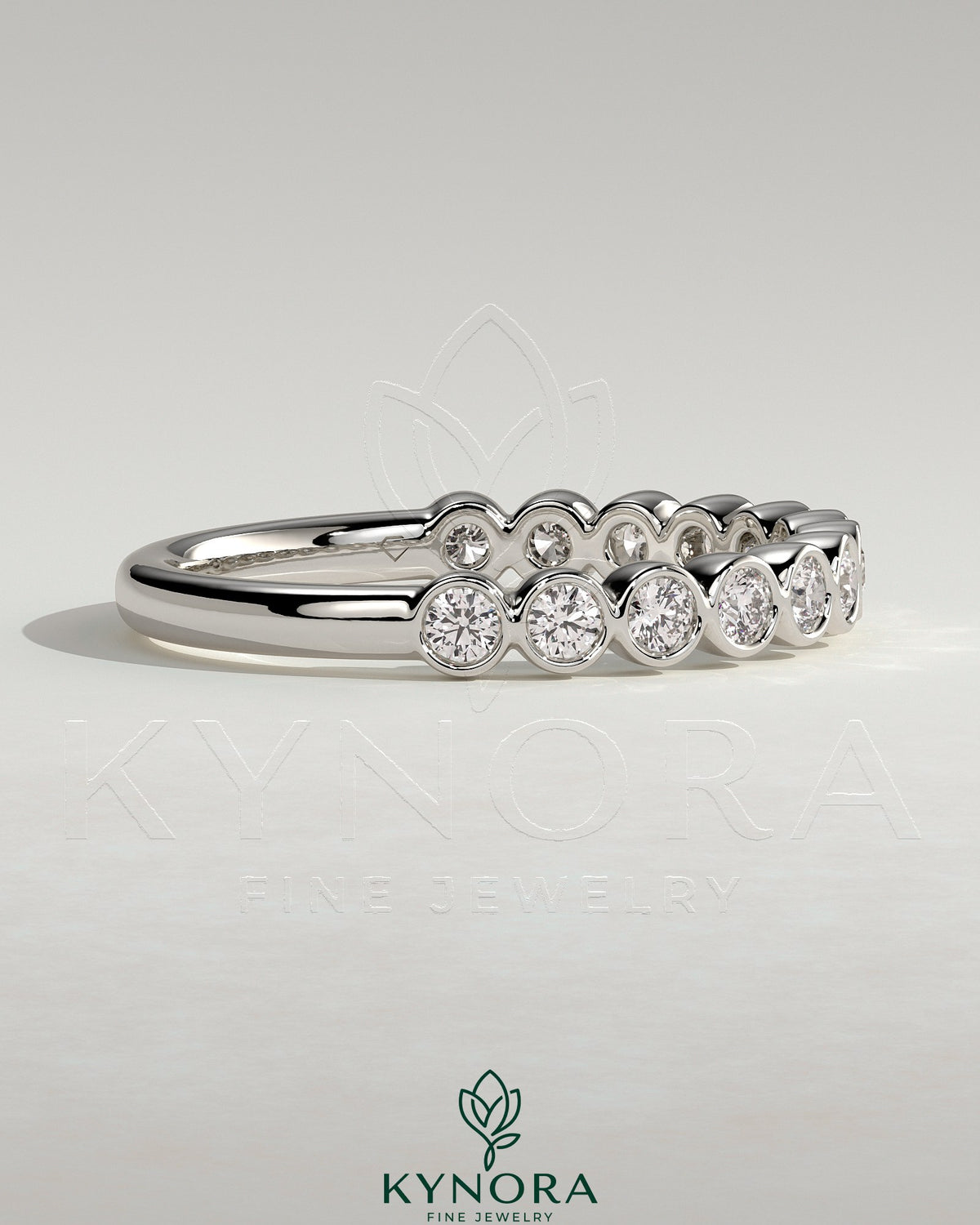 Kynora CJ half eternity wedding band with round bezel-set diamonds, elegant gold wedding ring for special occasions.