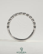 Kynora CJ half eternity round bezel set wedding ring with sparkling gemstones, elegant wedding band for special occasions.