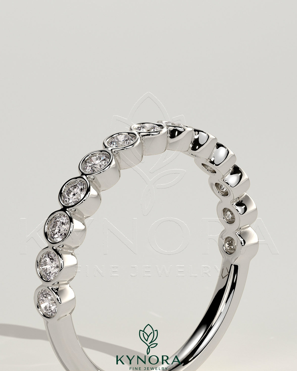 Kynora CJ half eternity wedding band with round bezel-set diamonds, showcasing a sleek and elegant design.