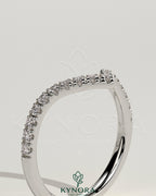 Half pave deep V band wedding ring by Kynora CJ with intricate pave detailing on a sleek gold band.