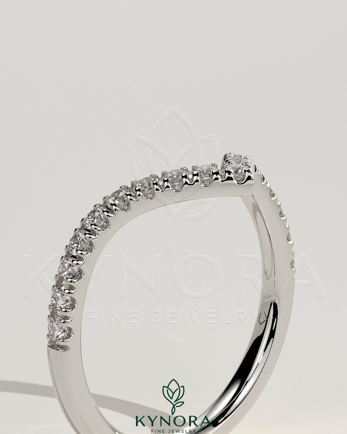Half pave deep V band wedding ring by Kynora CJ with intricate pave detailing on a sleek gold band.