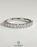 Kynora CJ half round eternity wedding band with scalloped setting, showcasing a sleek, polished gold finish and intricate design details.