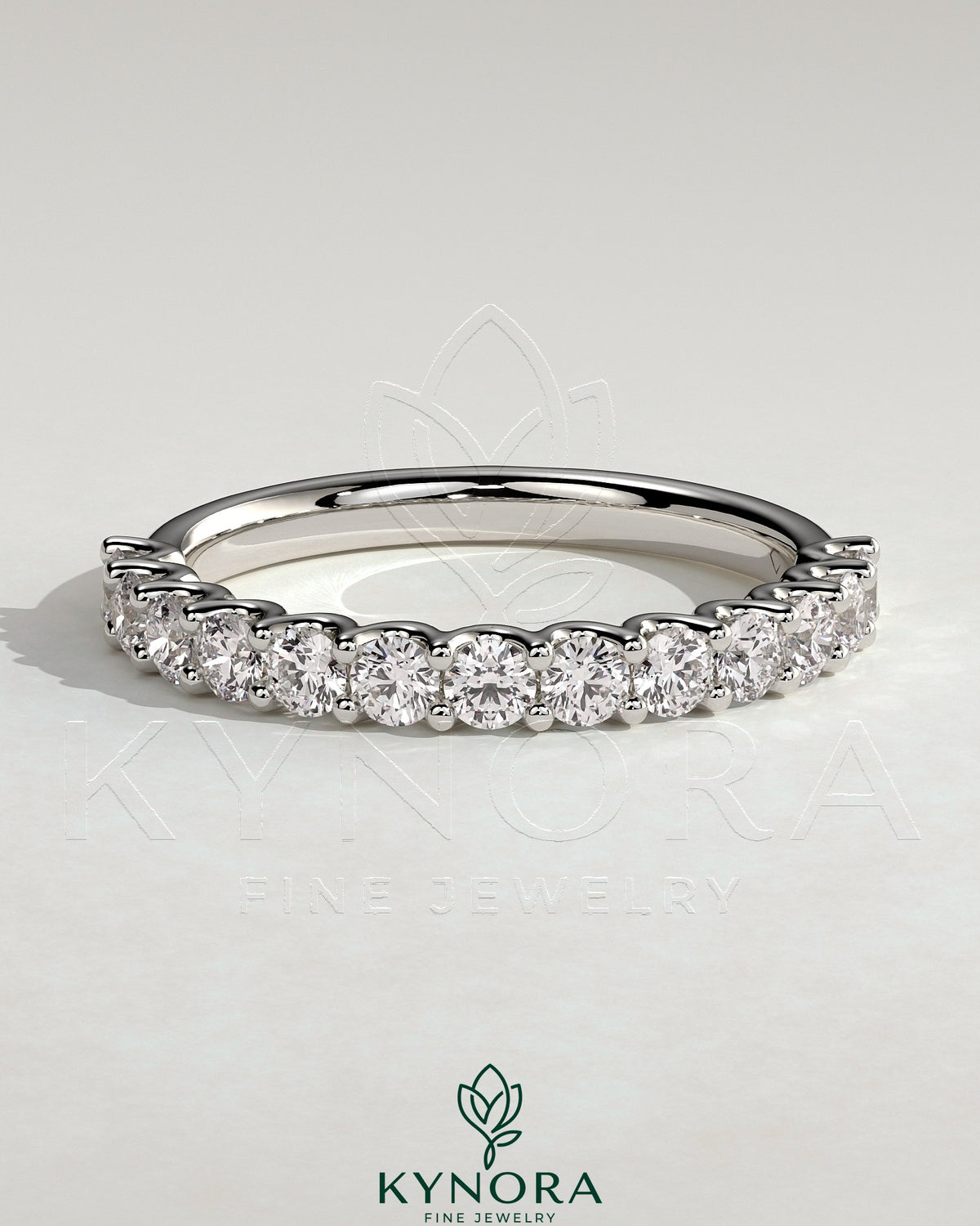 Kynora CJ half round eternity wedding band with scalloped setting, showcasing a sleek, polished gold finish and intricate design details.