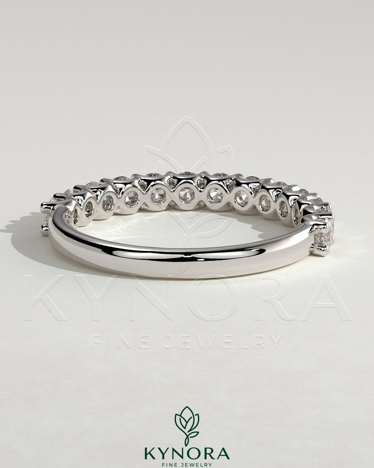 Kynora CJ half round eternity wedding band with scalloped setting, crafted in polished metal, featuring a continuous circle of gemstones.