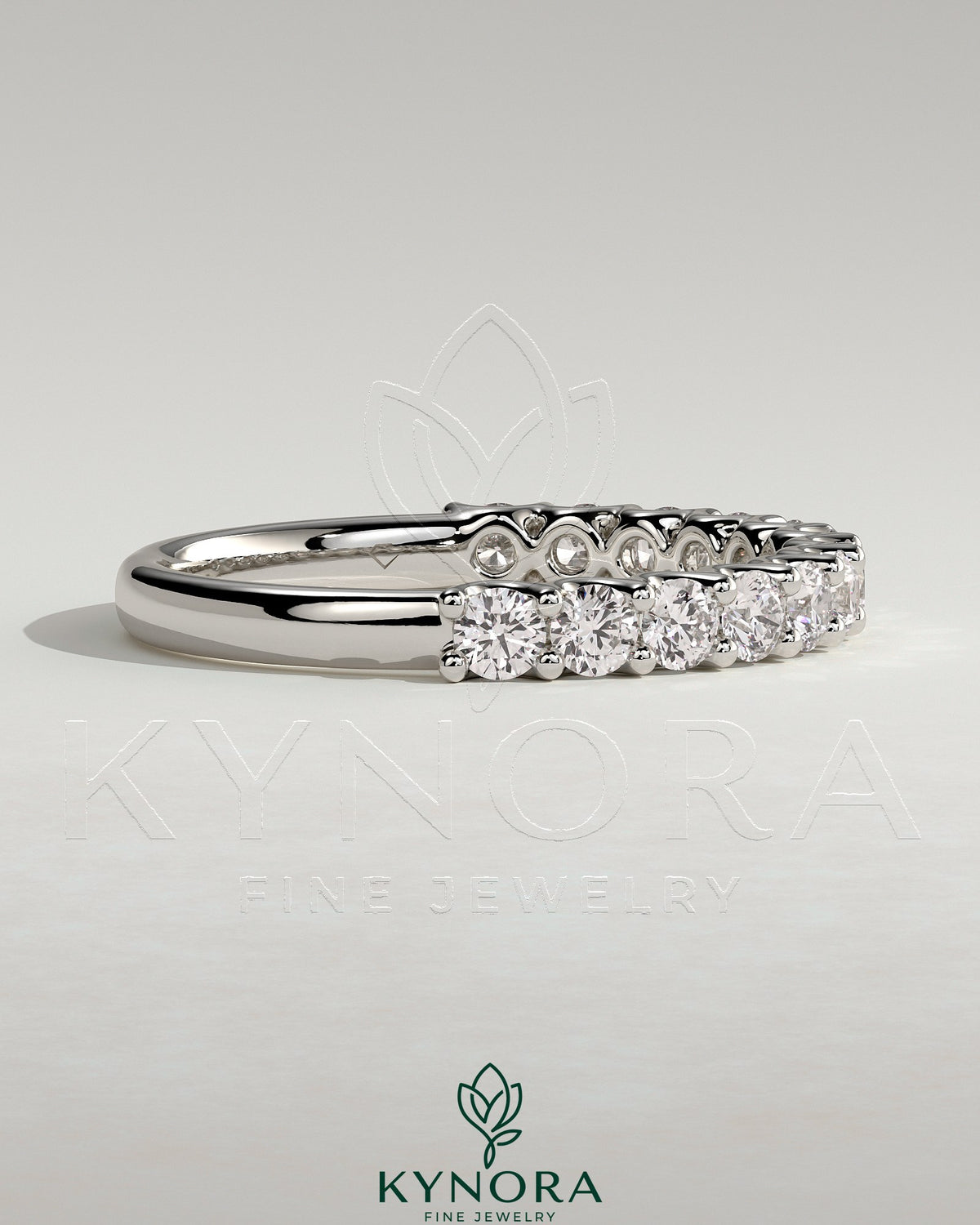 Elegant half round eternity wedding band with scalloped setting by Kynora CJ, showcasing intricate design and sparkling gemstones.