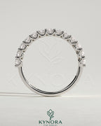 Half round eternity wedding band with scalloped setting by Kynora CJ, showcasing a polished gold finish and intricate design.