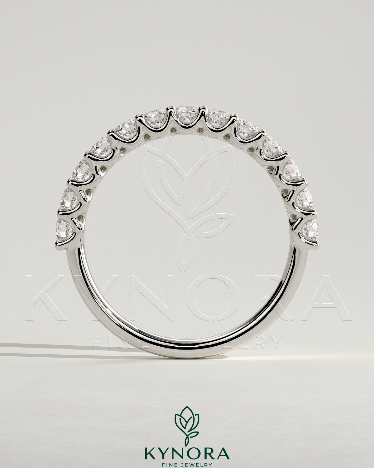 Half round eternity wedding band with scalloped setting by Kynora CJ, showcasing a polished gold finish and intricate design.