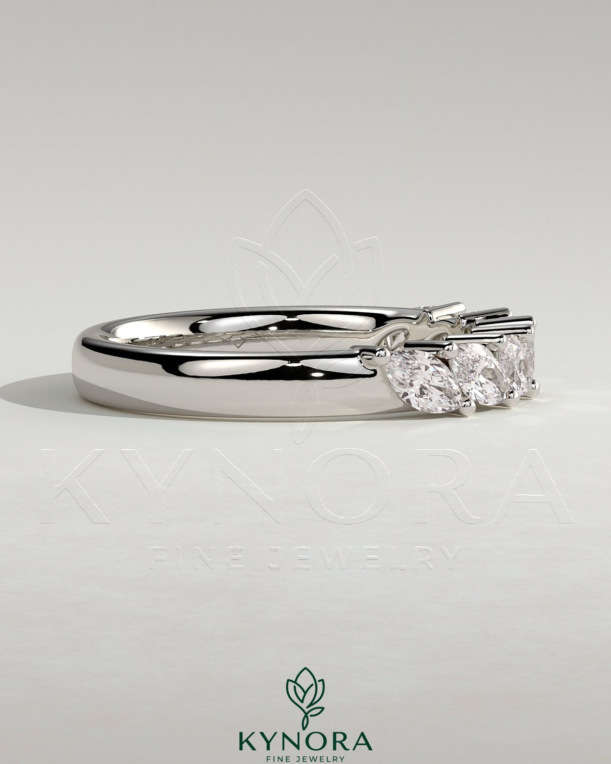 Kynora CJ Marquise East West accent wedding band with closed basket setting, featuring sparkling marquise stones in a elegant gold band.