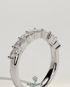 Kynora CJ Marquise East West accent wedding band with closed basket setting, featuring sparkling marquise-shaped stones.