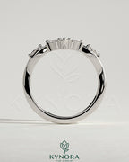 Kynora CJ wedding band with marquise and round accent stones in a vine design, elegant and sparkling gold ring for special occasions