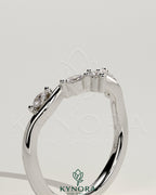 Kynora CJ wedding band with marquise and round accent stones in a vine design, crafted for elegant bridal jewelry.