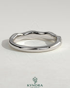 Mixed size pave band wedding ring with milgrain detailing by Kynora CJ, showcasing sparkling pave stones and intricate milgrain edges.