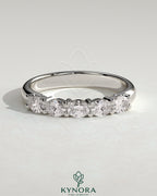 Kynora CJ sterling silver wedding band with oval east-west moissanite accent stone in closed basket setting