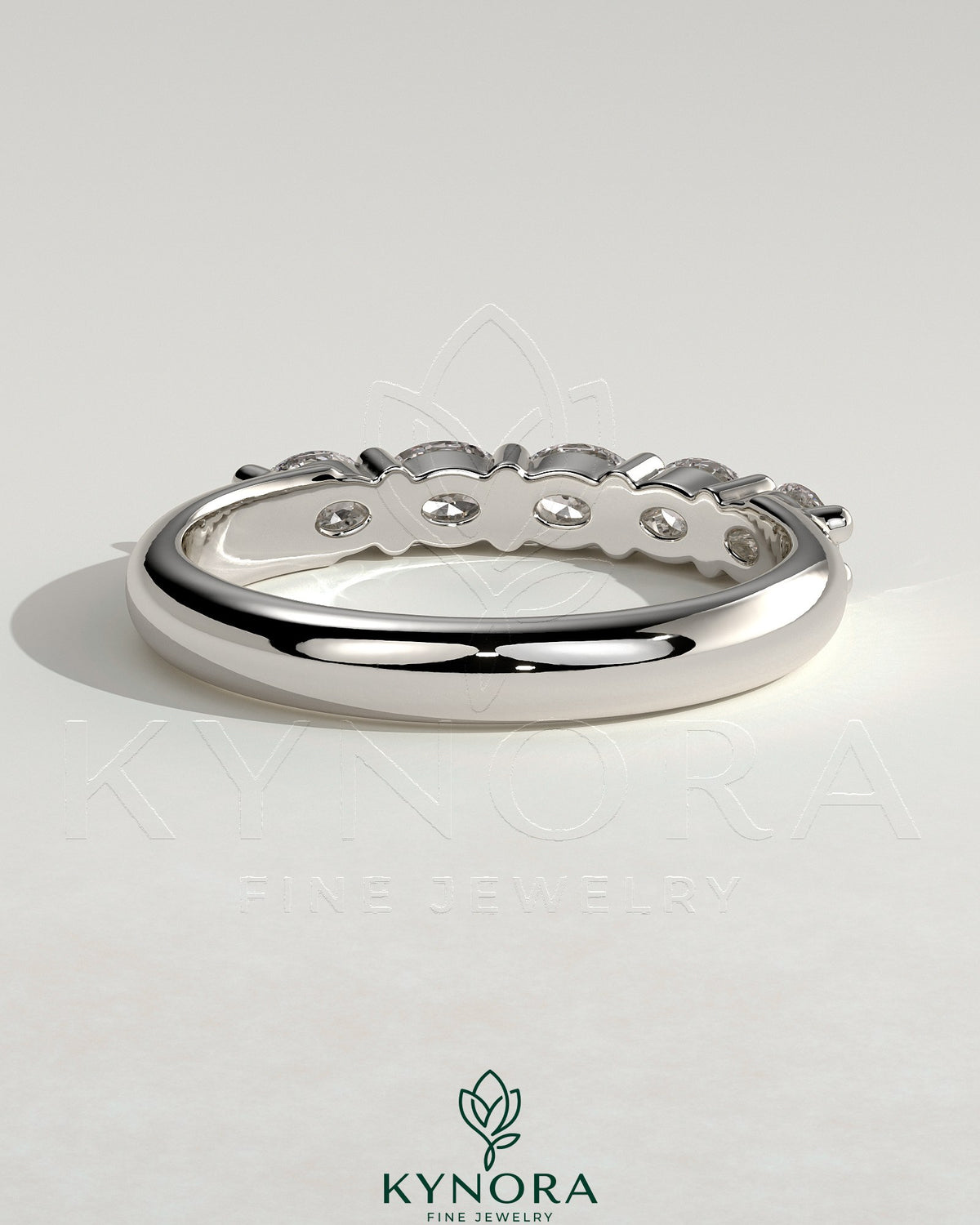 Kynora CJ sterling silver wedding band with oval east-west moissanite accent stone in closed basket setting.