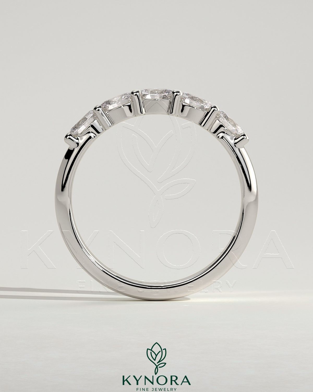 Kynora CJ sterling silver wedding band with oval east-west moissanite accent stone in closed basket setting.
