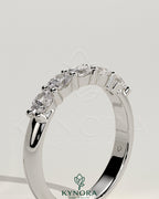 Kynora CJ sterling silver wedding band with oval east-west moissanite accent stone in closed basket setting