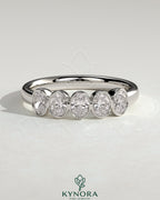 Kynora CJ oval bezel set wedding band in silver with a smooth, polished finish, designed for elegant bridal jewelry.