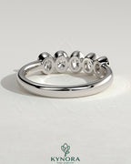Kynora CJ oval bezel set wedding band with a sleek, polished design for a timeless bridal ring.