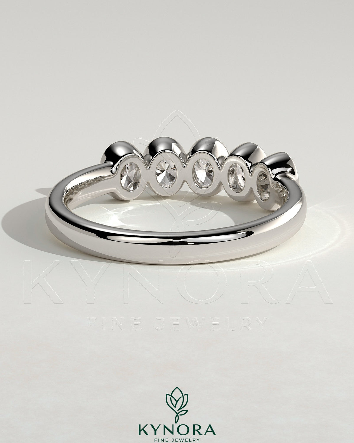 Kynora CJ oval bezel set wedding band with a sleek, polished design for a timeless bridal ring.