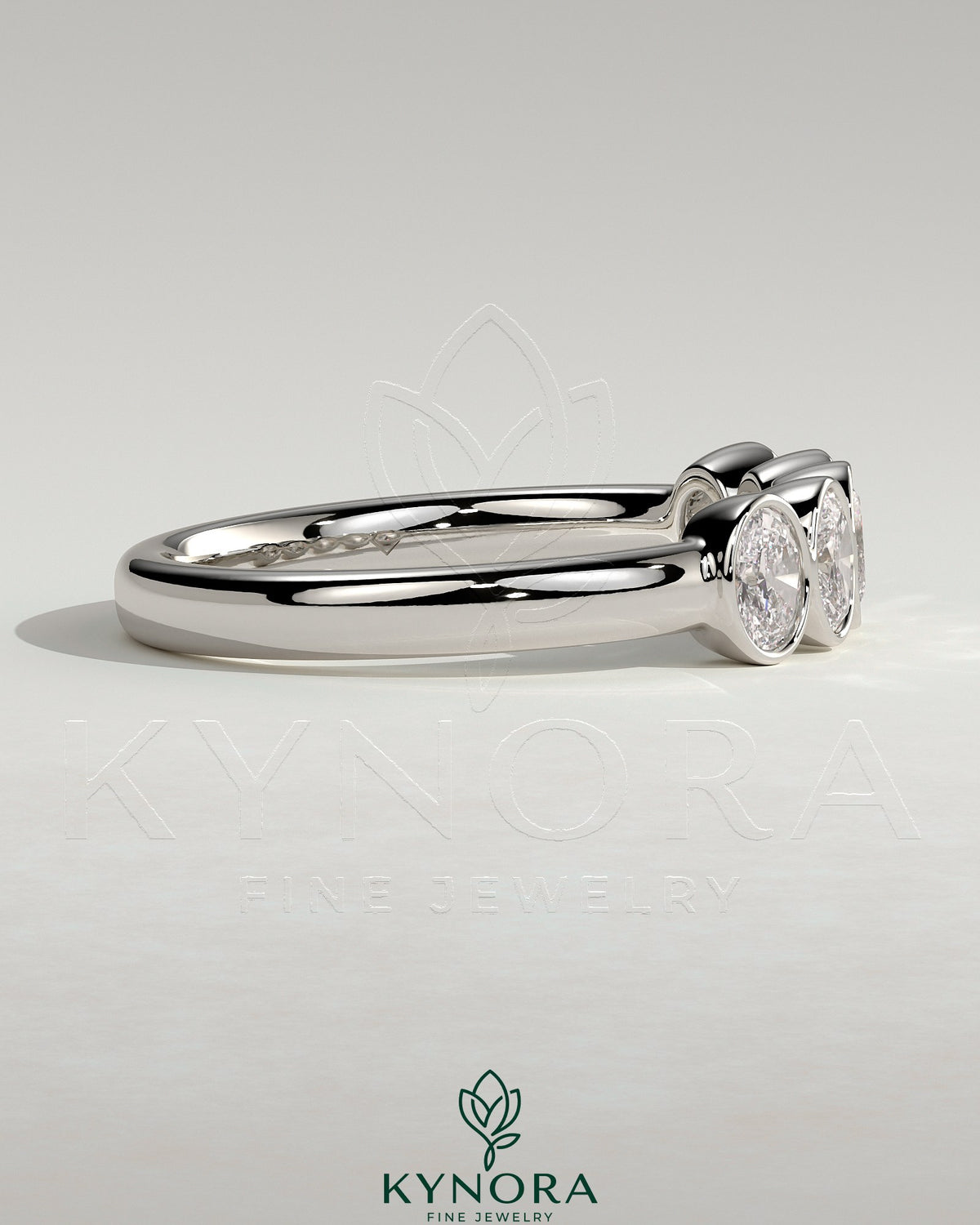 Oval bezel set wedding ring by Kynora CJ, featuring a sleek band with an elegant oval gemstone setting.
