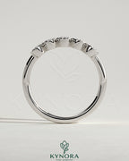 Kynora CJ oval bezel set wedding band with a sleek gold finish, featuring a central oval-shaped diamond for elegant style.