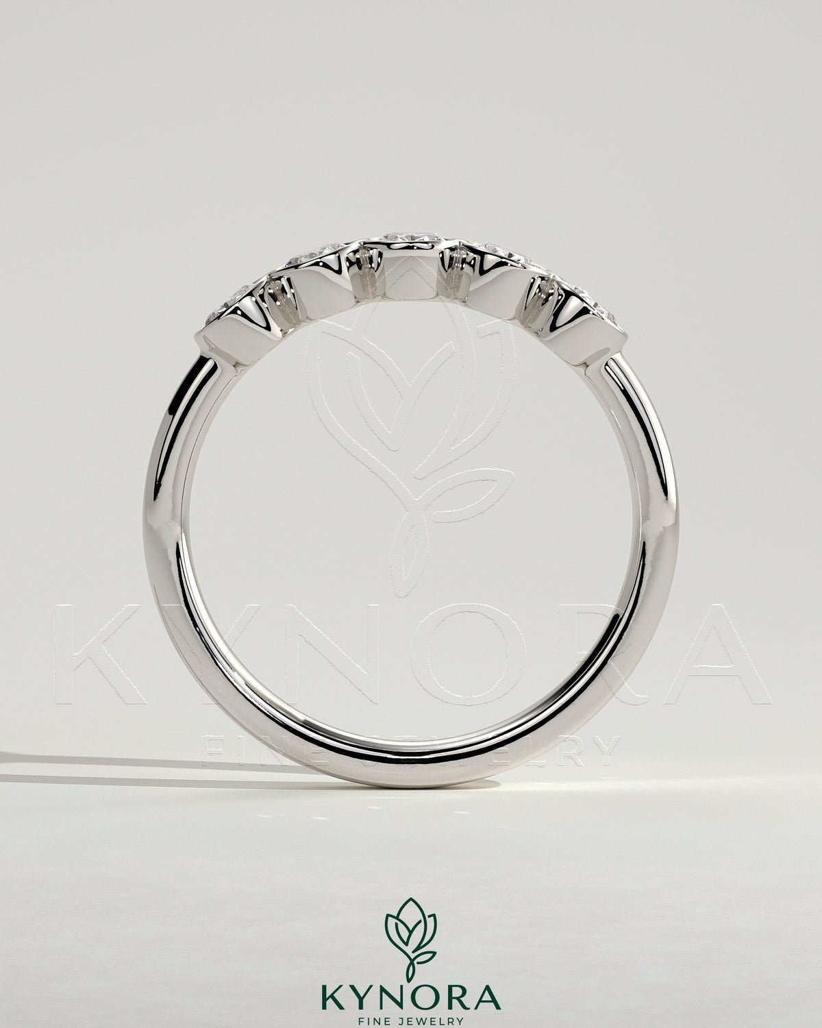 Kynora CJ oval bezel set wedding band with a sleek gold finish, featuring a central oval-shaped diamond for elegant style.