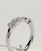 Kynora CJ oval bezel set wedding ring with a sleek band, featuring a central oval gemstone in a modern wedding band design.