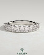 Kynora CJ Oval Eternity Band wedding ring with oval-shaped design and sparkling gemstones, crafted in elegant jewelry style.