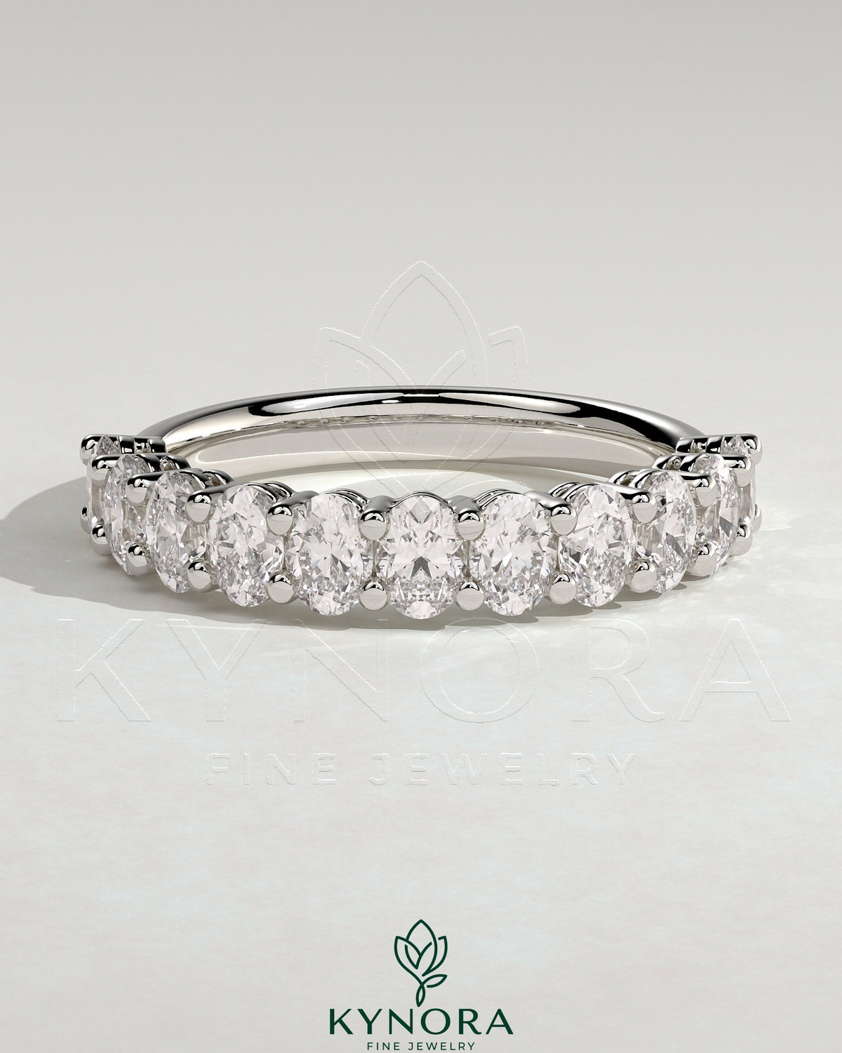 Kynora CJ Oval Eternity Band wedding ring with oval-shaped design and sparkling gemstones, crafted in elegant jewelry style.