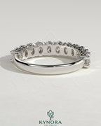 Kynora CJ oval eternity band wedding ring featuring a continuous row of oval-shaped diamonds on a sleek gold band.