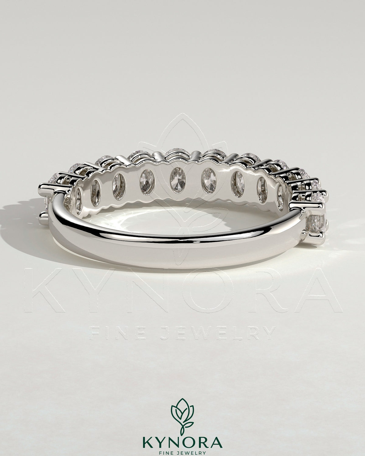 Kynora CJ oval eternity band wedding ring featuring a continuous row of oval-shaped diamonds on a sleek gold band.