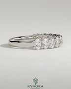 Kynora CJ oval eternity wedding band with sparkling gemstone accents, elegant design for special occasions.