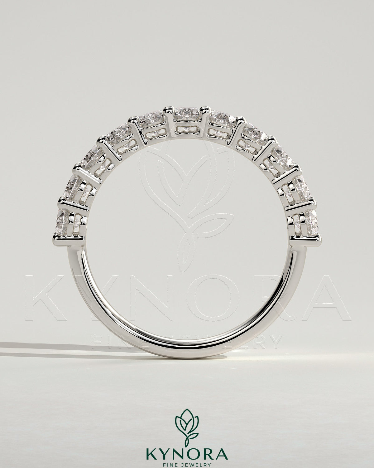 Kynora CJ oval eternity wedding band ring with continuous sparkling gemstone design on polished metal band