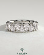 Kynora CJ Pear alternating half eternity wedding band with closed basket setting, featuring sparkling pear-shaped gemstones.