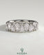 Kynora CJ Pear alternating half eternity wedding band with closed basket setting, featuring sparkling pear-shaped gemstones.