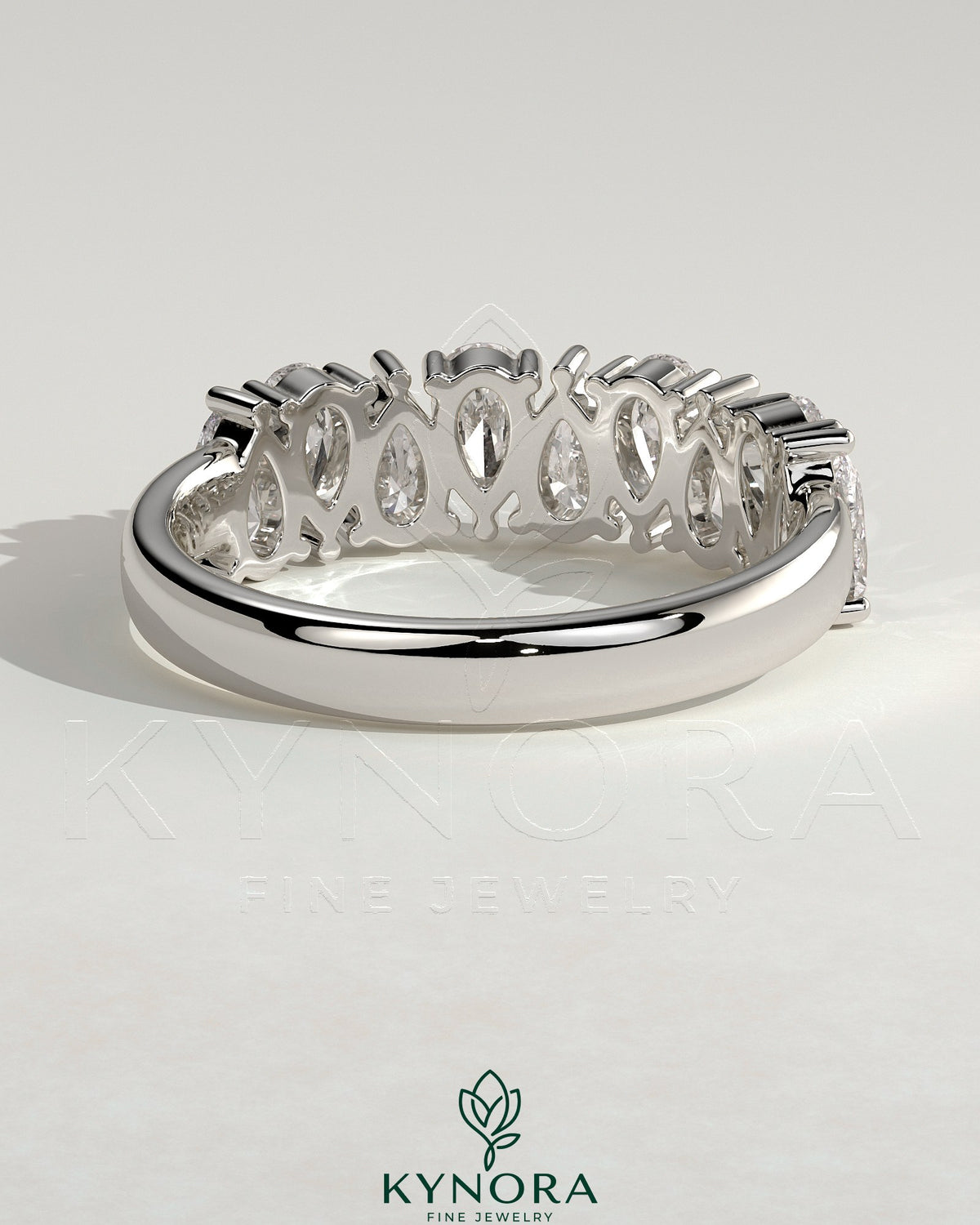 Kynora CJ Pear Alternating Half Eternity Wedding Band with closed basket setting, featuring alternating pear-shaped diamonds.