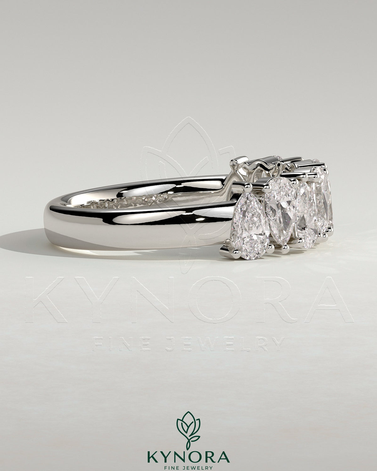 Kynora CJ pear alternating eternity wedding band with half pear-shaped stones in closed basket setting, crafted for elegance.