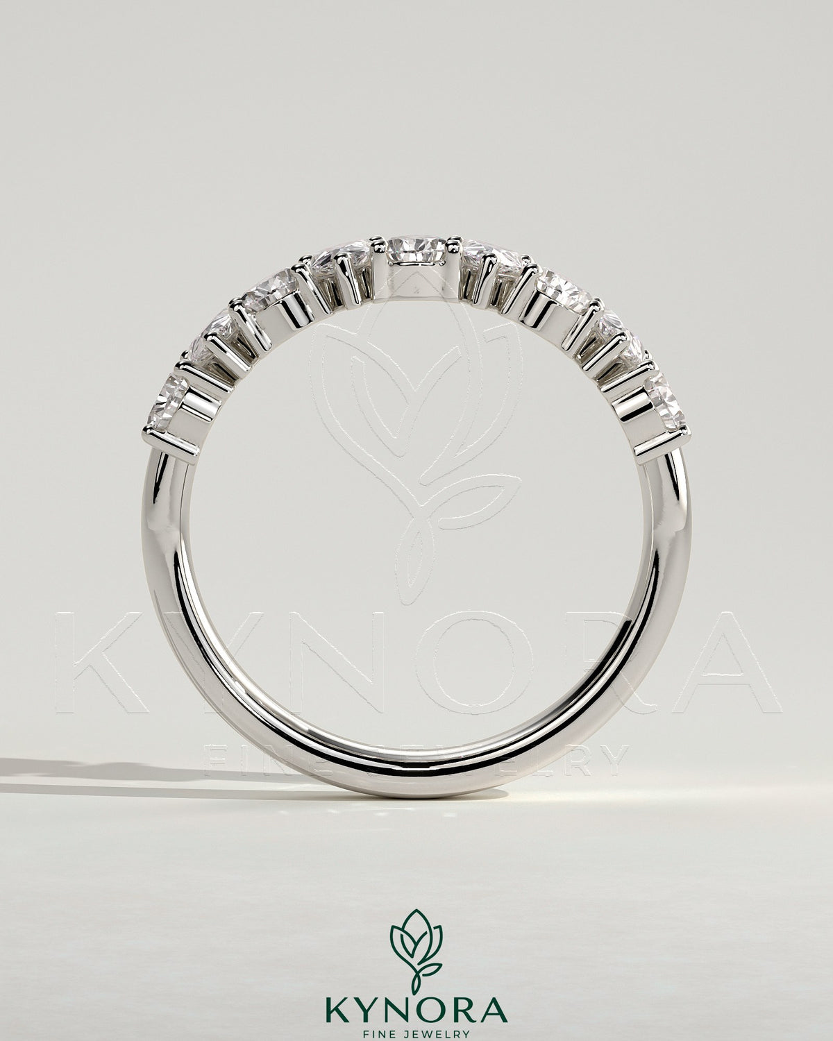 Kynora CJ Pear alternating half eternity wedding band with closed basket setting, featuring sparkling gemstones in a delicate design.