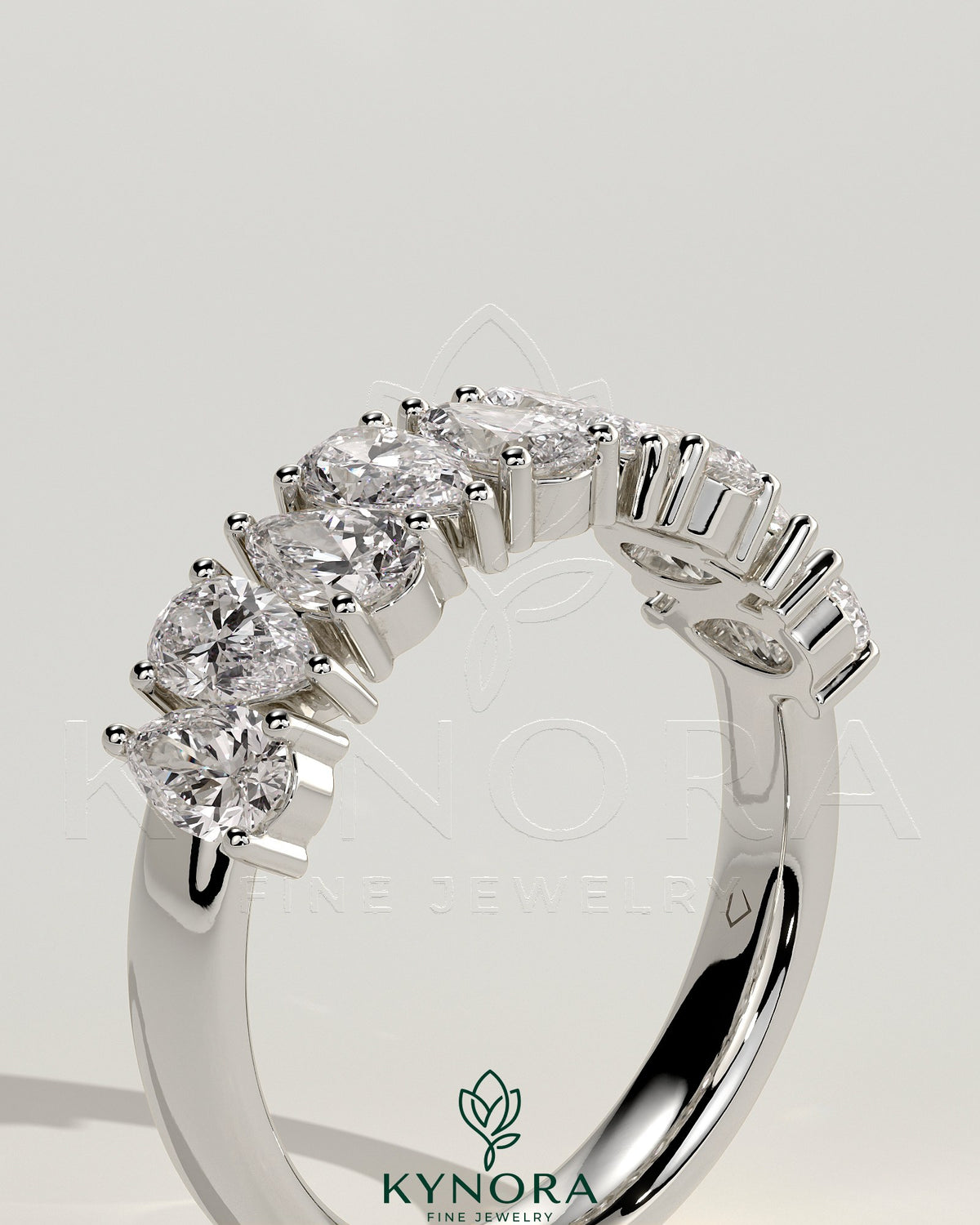 Kynora CJ Pear Alternating Half Eternity Wedding Band with closed basket setting, featuring pear-shaped diamonds on a polished gold band