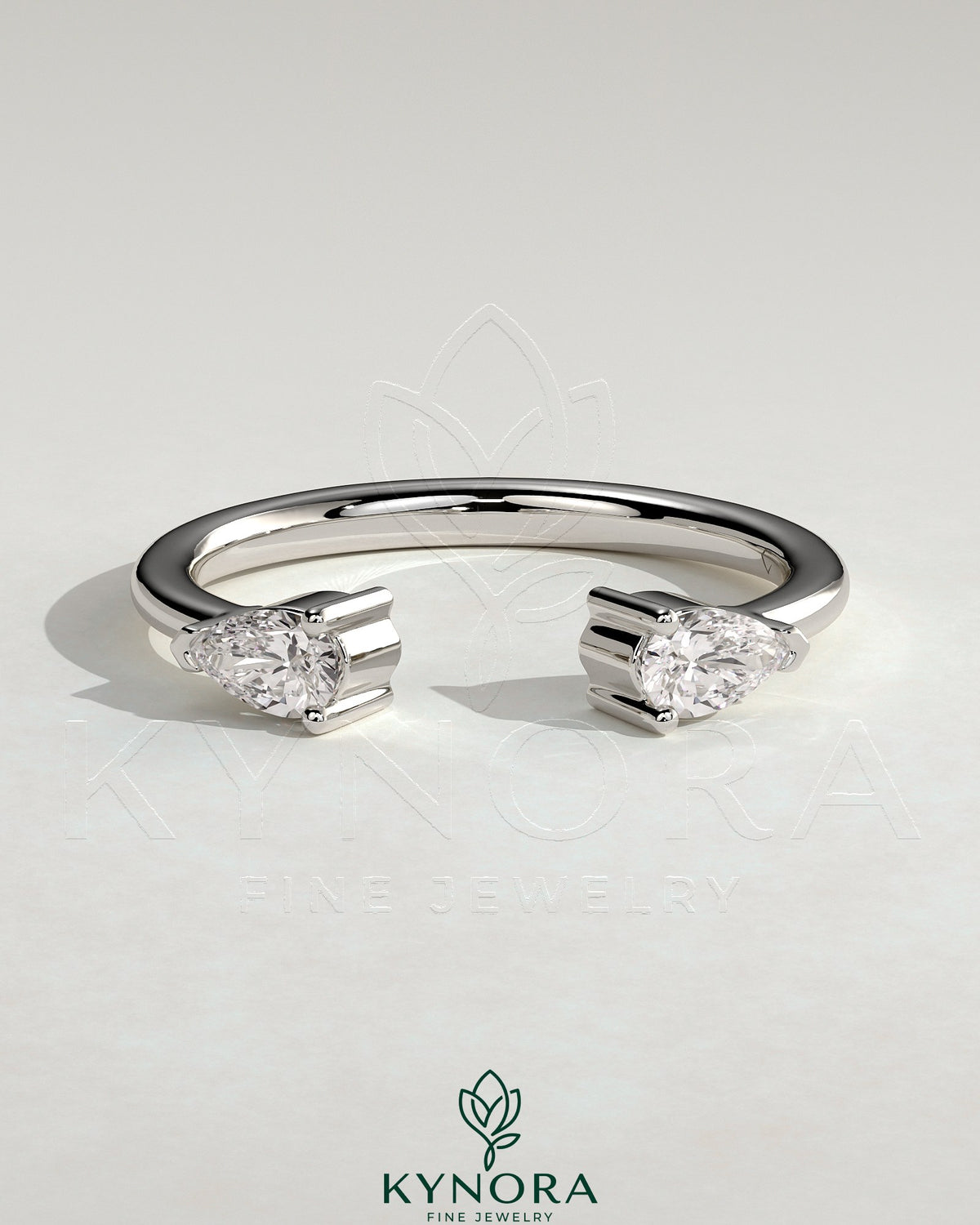 Kynora CJ Pear Accent Stone open band wedding ring with elegant design and sparkling pear-shaped accents on a sleek gold band.