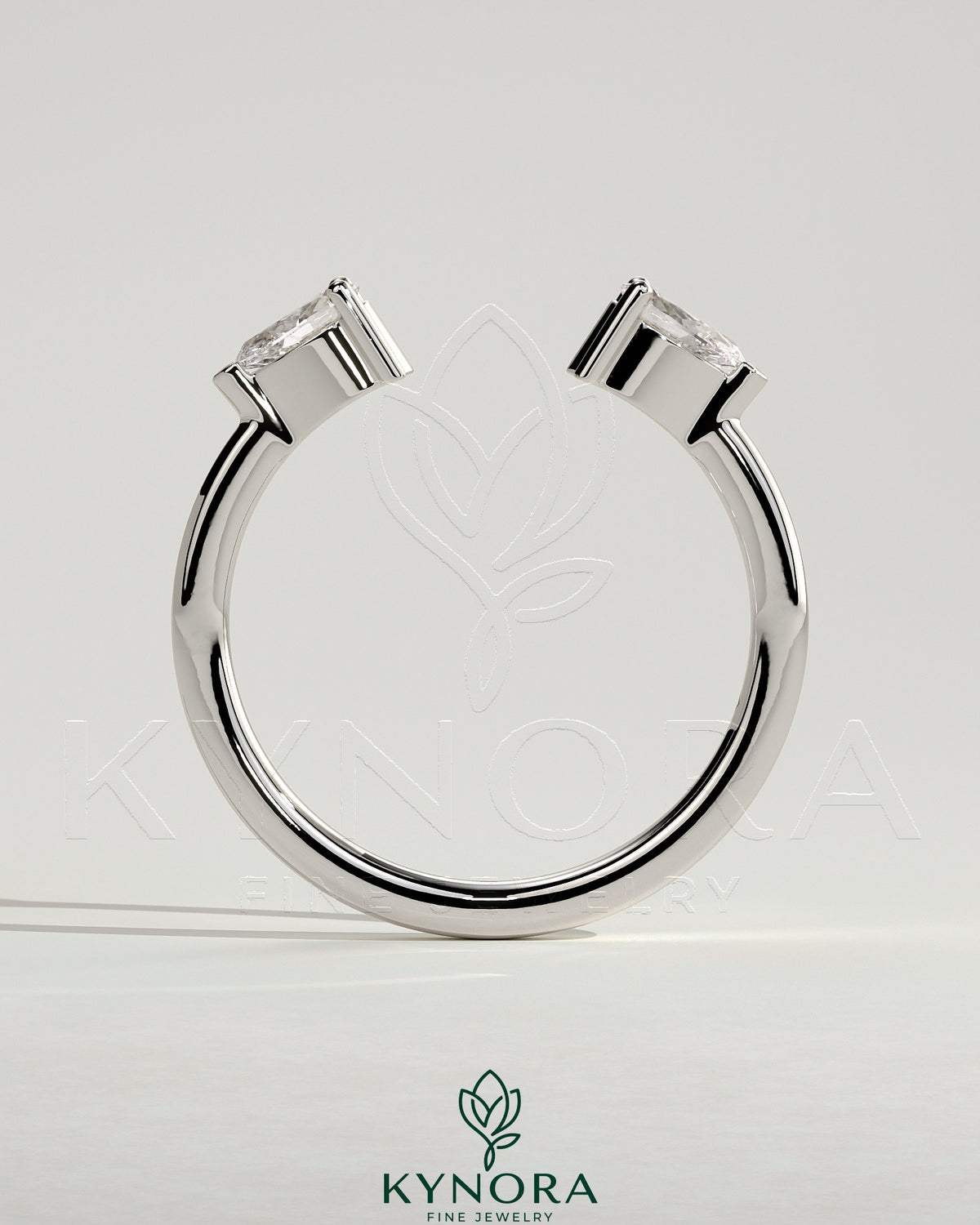 Kynora CJ Pear accent stone open band wedding ring with elegant design and sparkling gemstones on a silver finish.