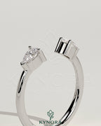 Kynora CJ Pear Accent Stone open band wedding ring with elegant design and sparkling gemstones on a silver band.
