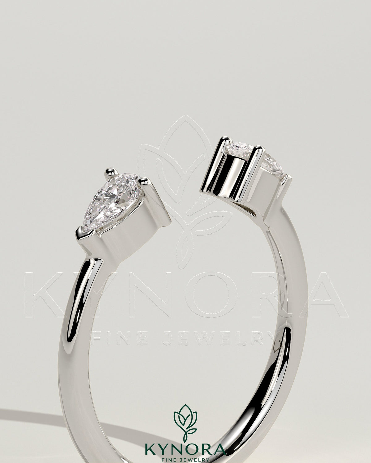 Kynora CJ Pear Accent Stone open band wedding ring with elegant design and sparkling gemstones on a silver band.